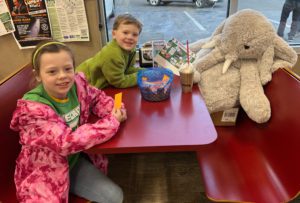 A student with Veda the stuffed elephant at Stewart's in Rensselaer