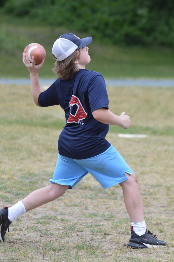 Student throwing a football at the 5th Grade Mixer
