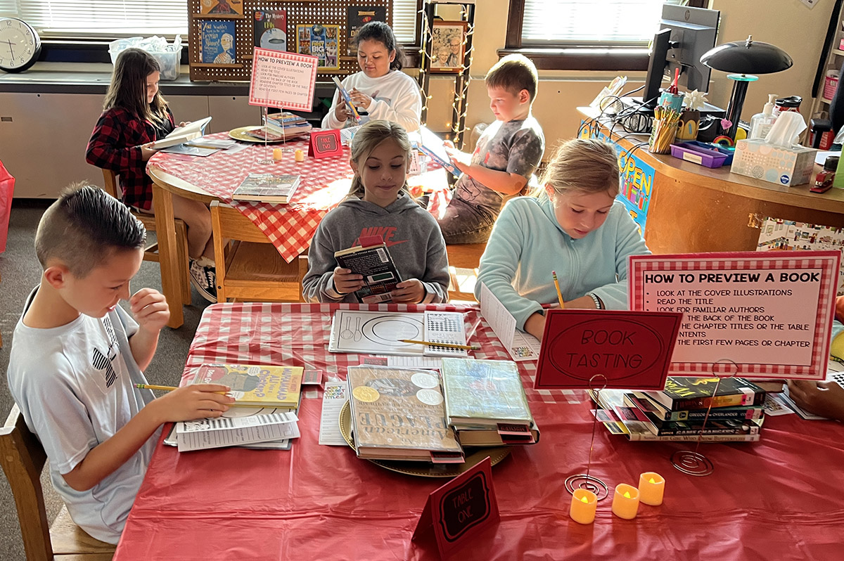 Students try out different books at a Book Tasting in the DPS Library.