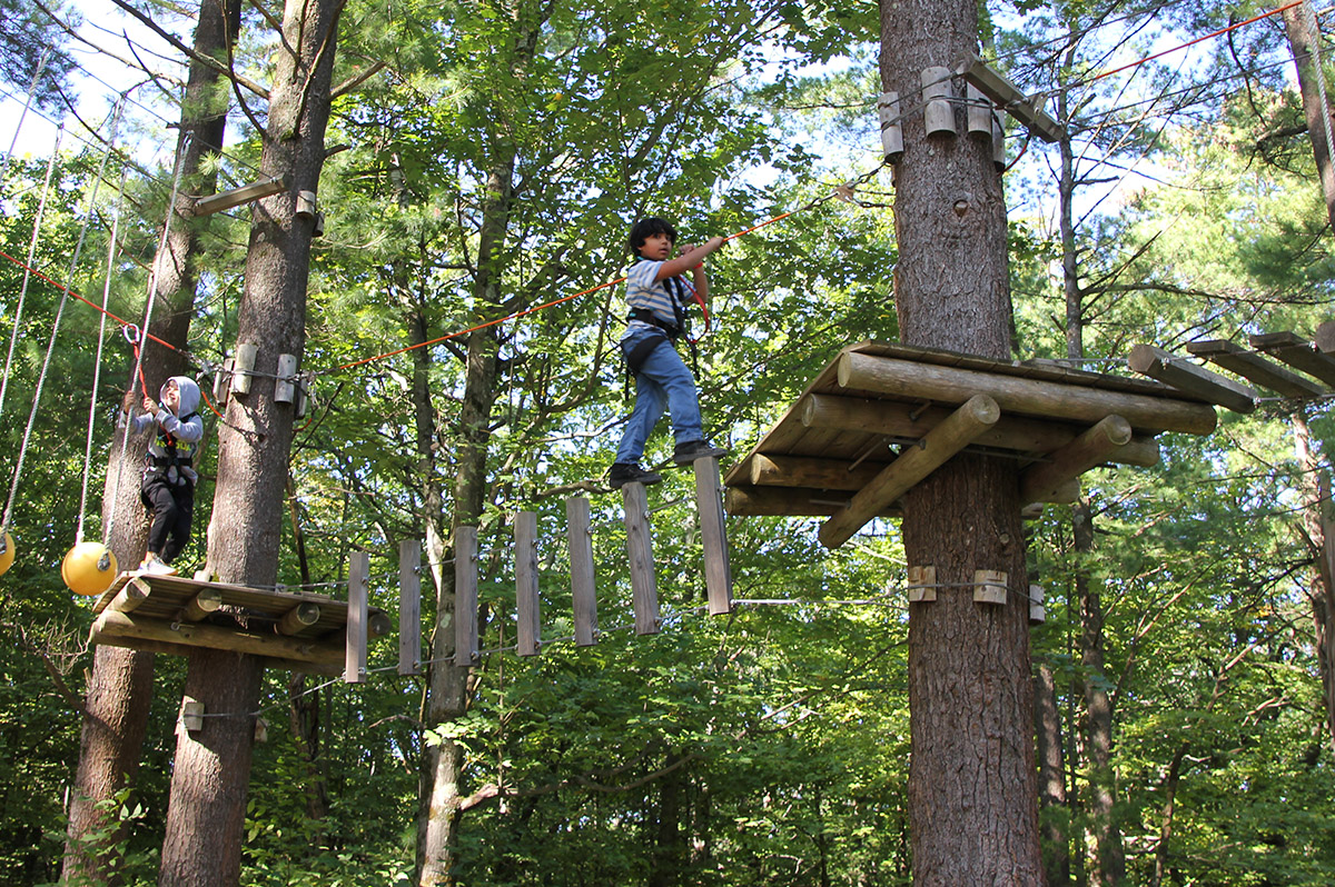 Genet 5th grade students climbing the WildPlay ropes course at Thacher State Park.