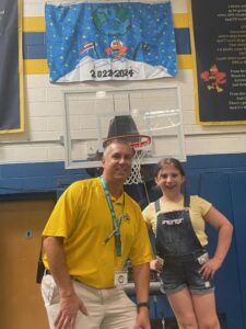 Principal Jack Alvey and Molly Hatch at school assembly