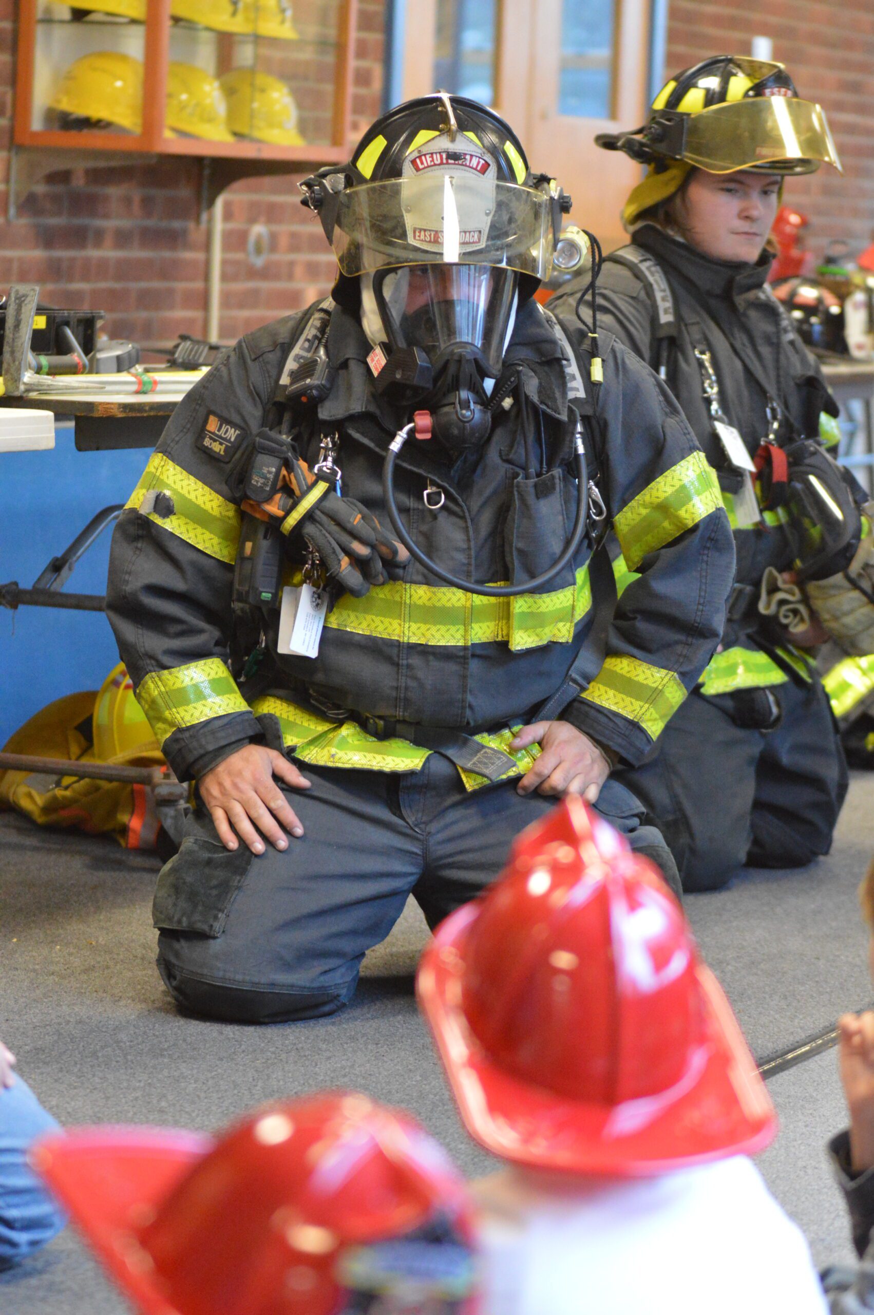 Firefighters lead fire safety talks with students.