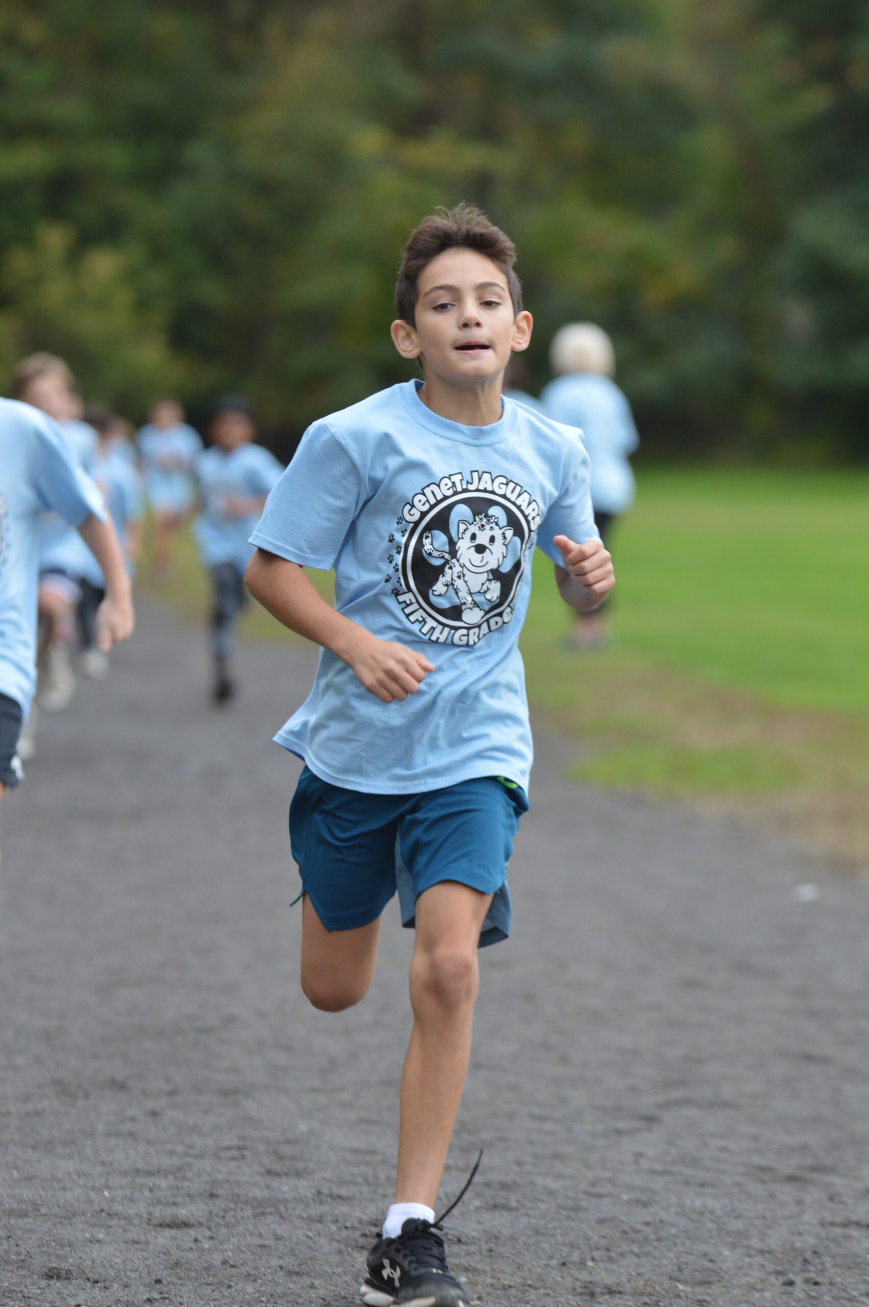 A student runs in the Genet Fall Fun Run.