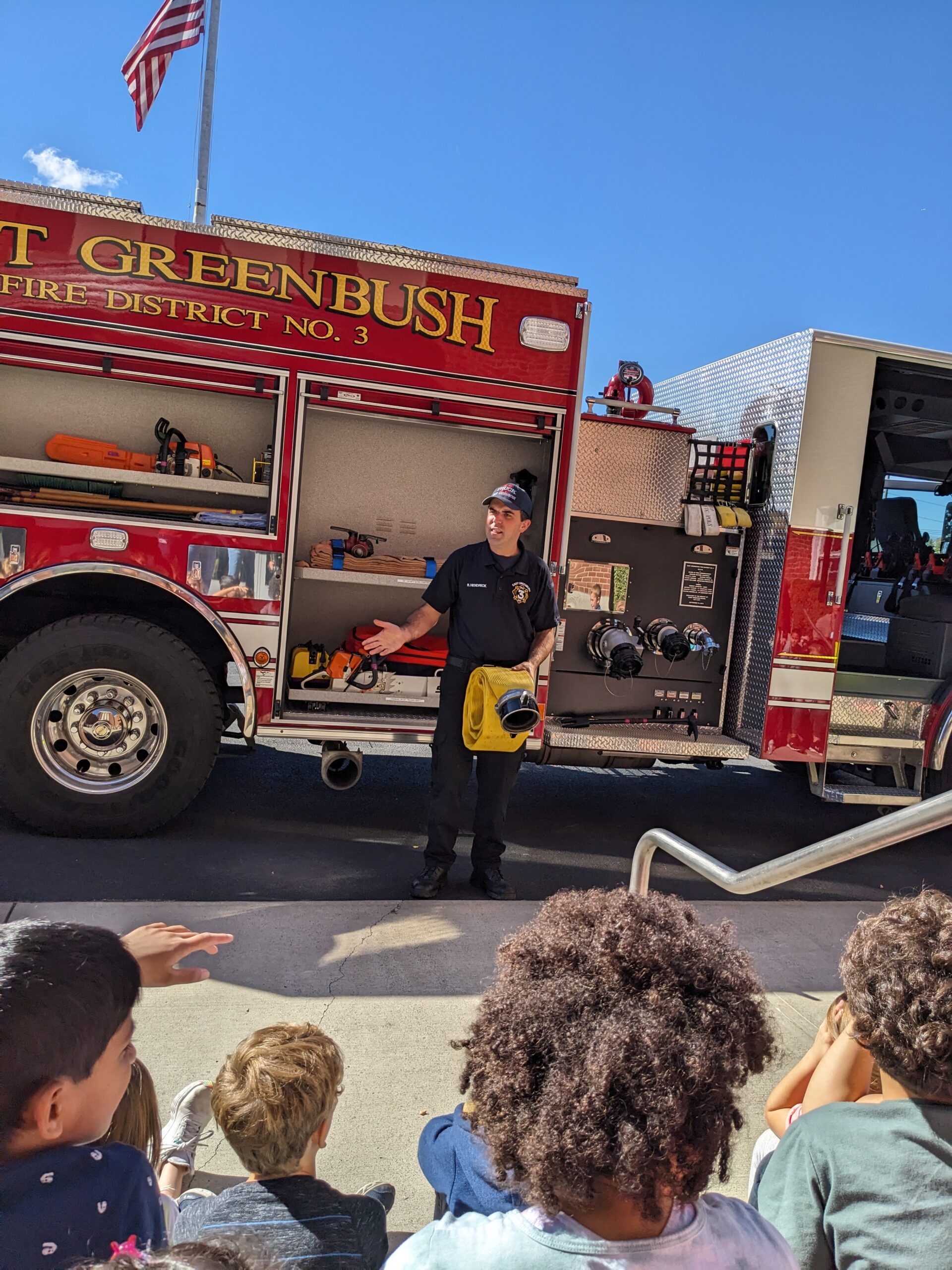 Firefighters lead fire safety talks with students.