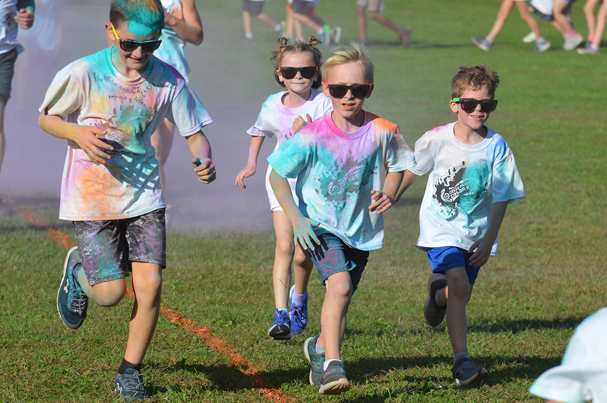 Students running in the 2023 Green Meadow Color Run.