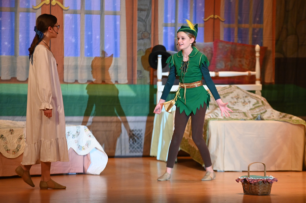 Students act on stage during a dress rehearsal of Peter Pan Jr.