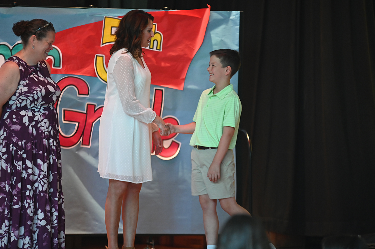 Student receiving certificate at the 2024 Green Meadow 5th Grade Moving Up Ceremony