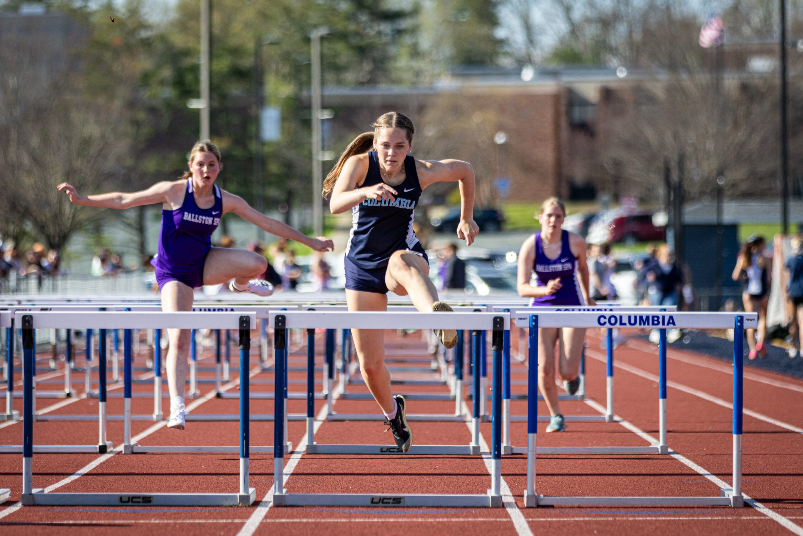 Kamilla Conboy running in the hurdles at Columbia High School