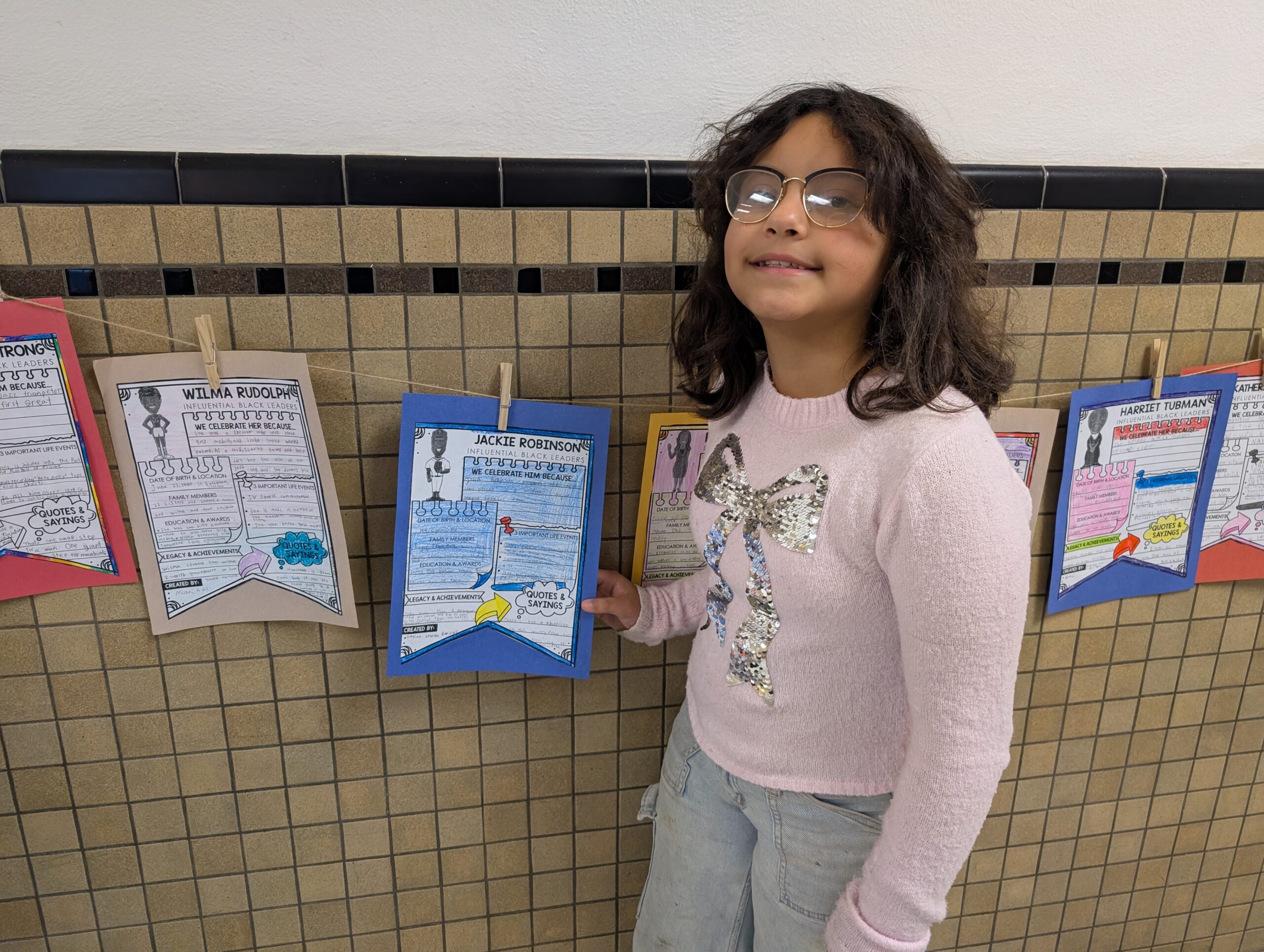 A student holds their Black History Month research projects
