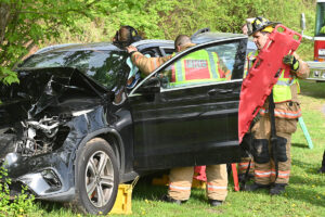 Firefighters help a student during a simulated accident as part of a Mock DWI event on the Columbia High School campus.