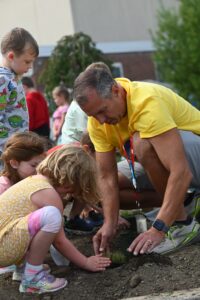 DPS Principal Jack Alvey working with students to build the new pollinator garden on Wednesday.