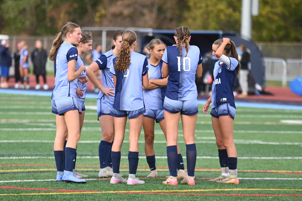 Girls' Soccer players huddle during a game vs. Burnt Hills-Ballston Lake