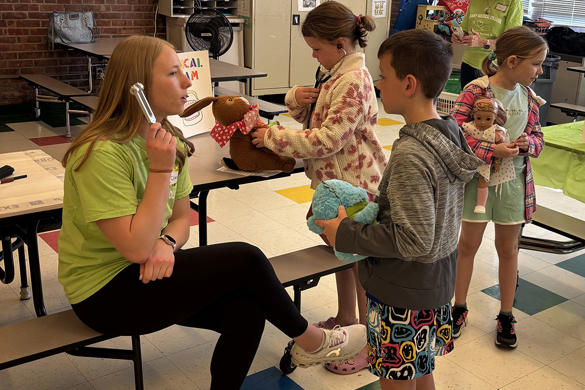 A Green Meadow student has a stuffed animal checked by an Albany Medical Center student at a Teddy Bear Clinic in the school cafeteria