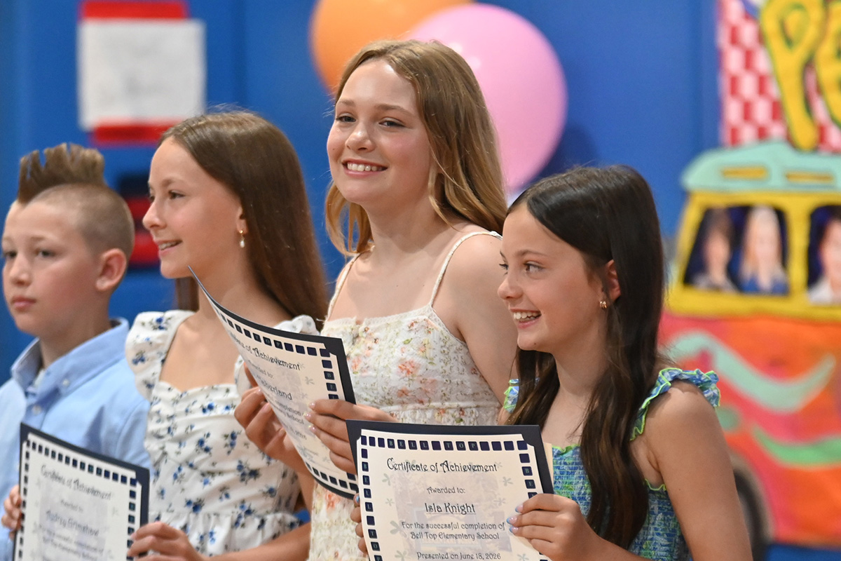 Bell Top 5th graders pose for photos holding their certificates