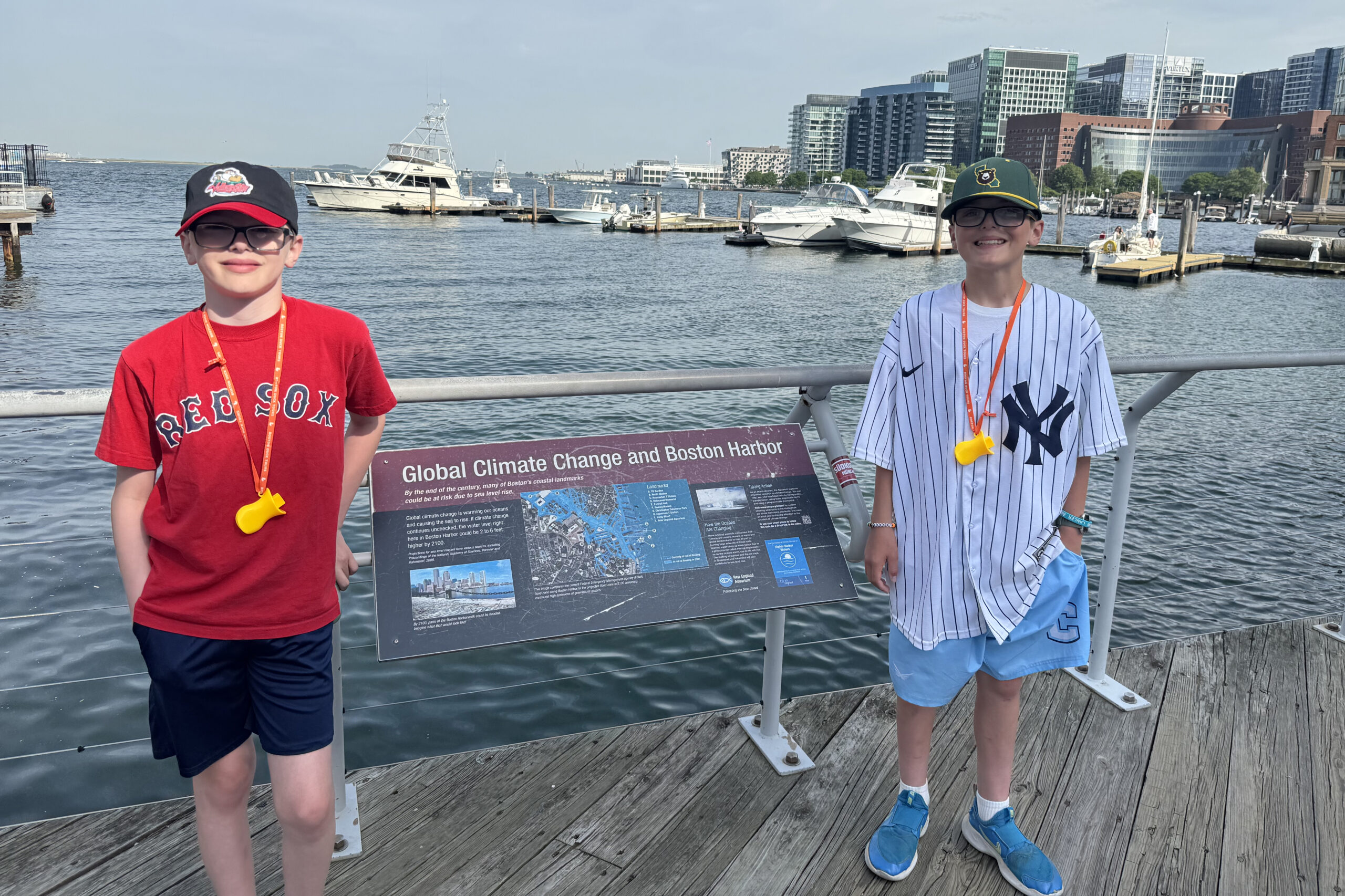 Two students in front of Boston harbor