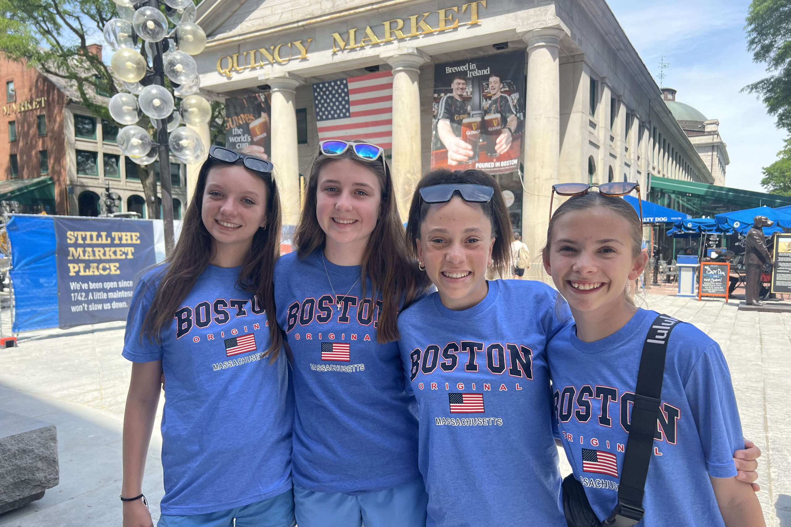 Four students at Quincy Market on the 7th grade class trip to Boston