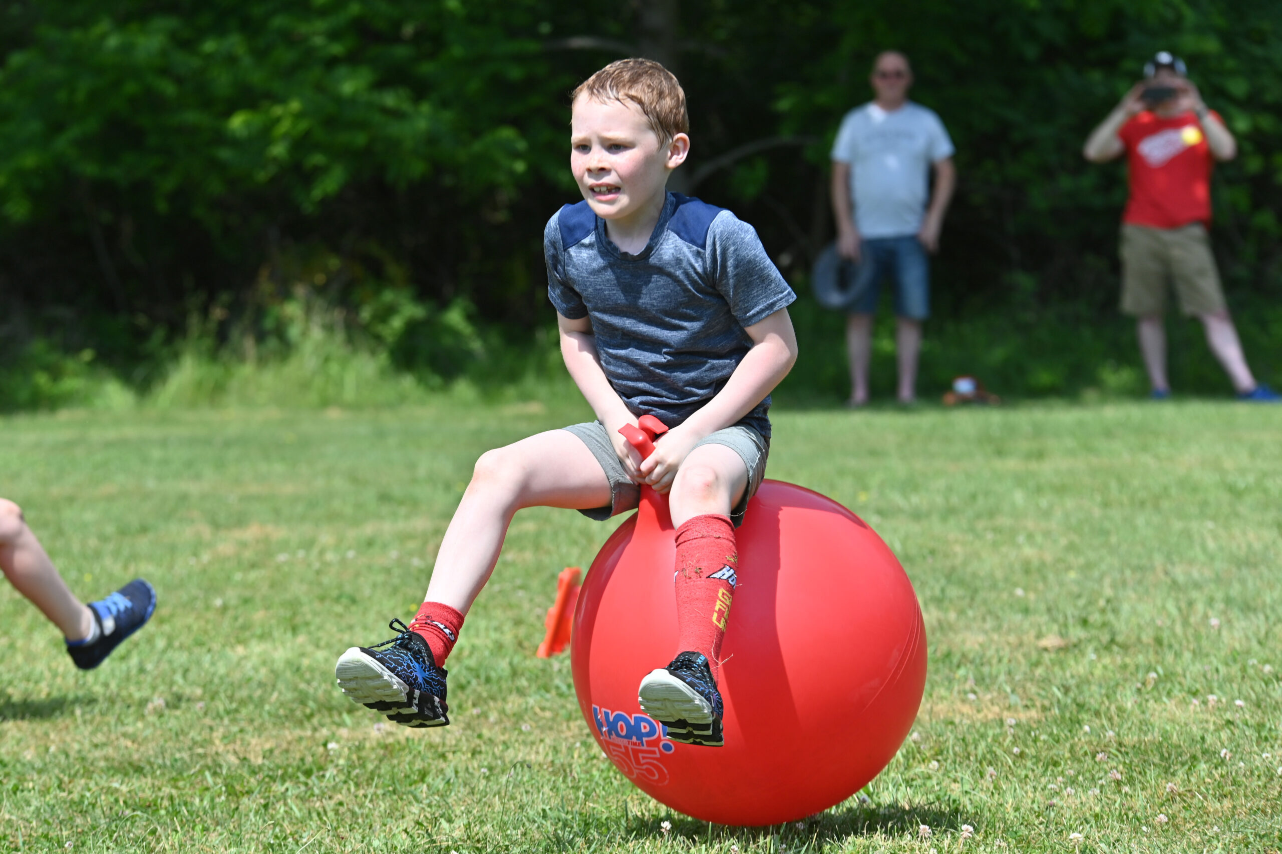 A student bounces on a hippity hop ball at DPS Field Day