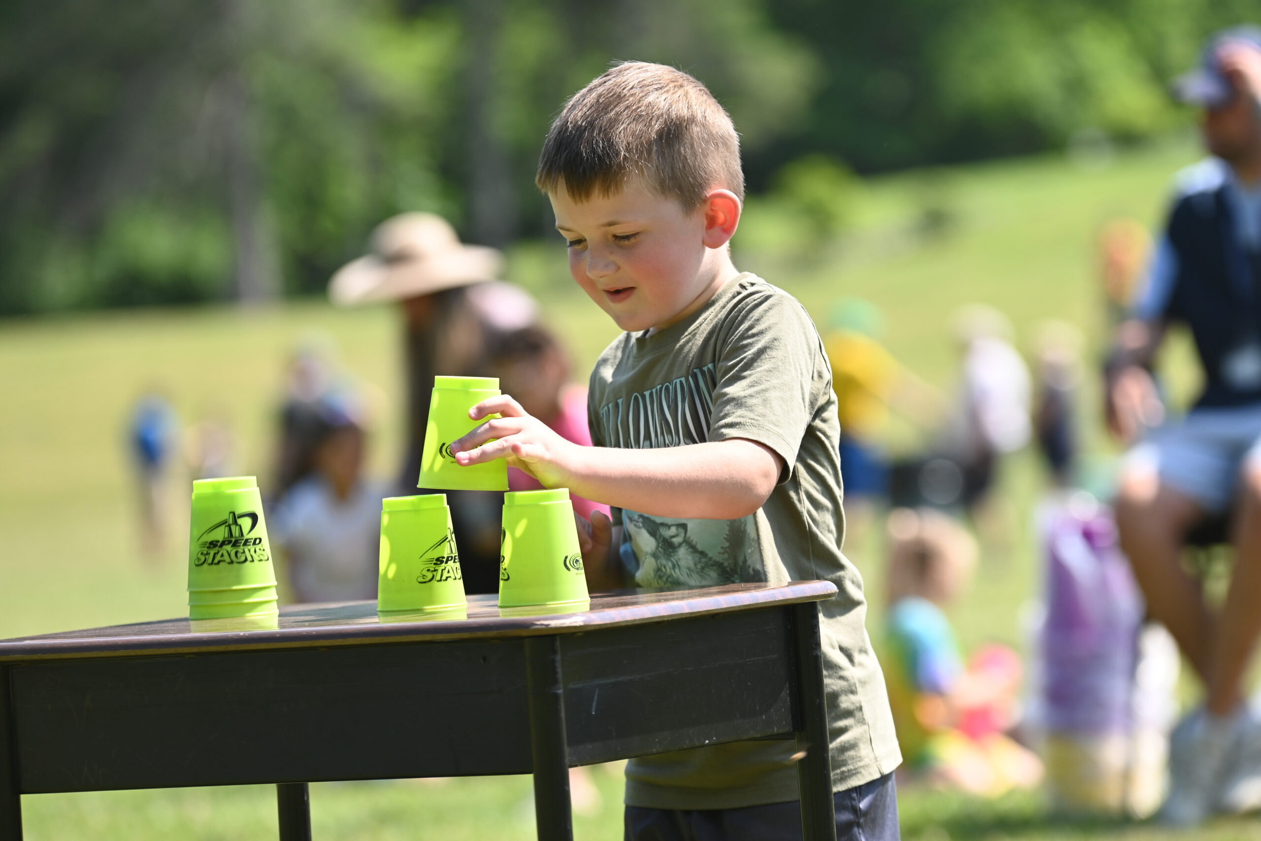 A student stacks cups during a race at DPS Field Day