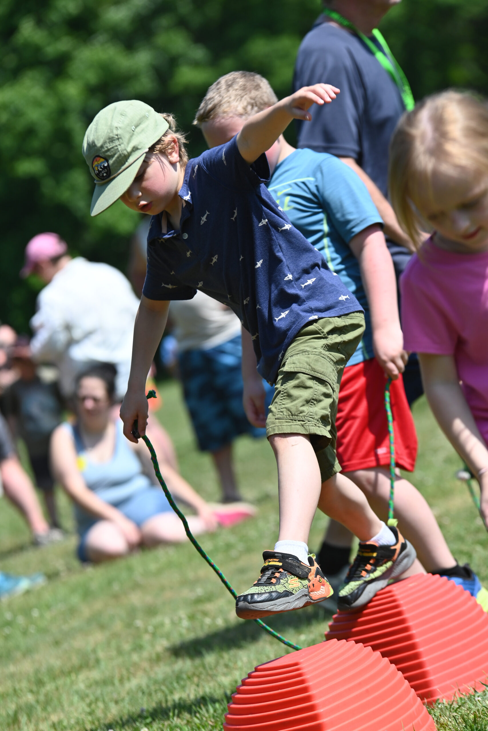 A student moves across stepping stones at DPS Field Day