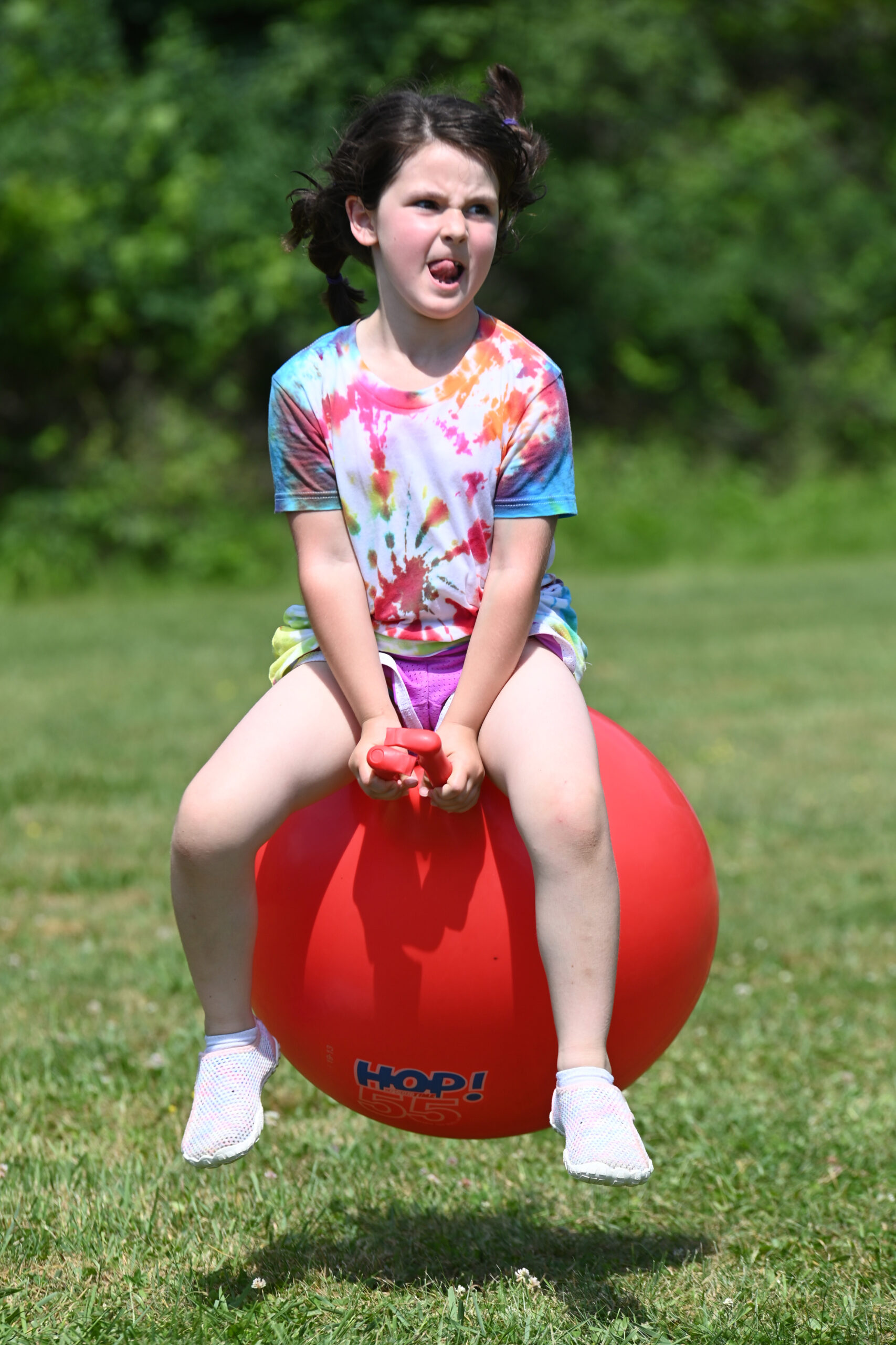 A student bounces on a hippity hop ball at DPS Field Day