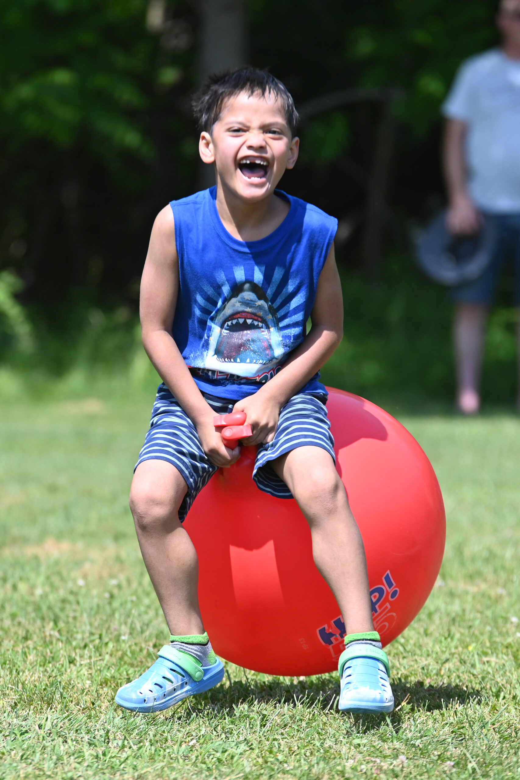A student bounces on a hippity hop ball at DPS Field Day
