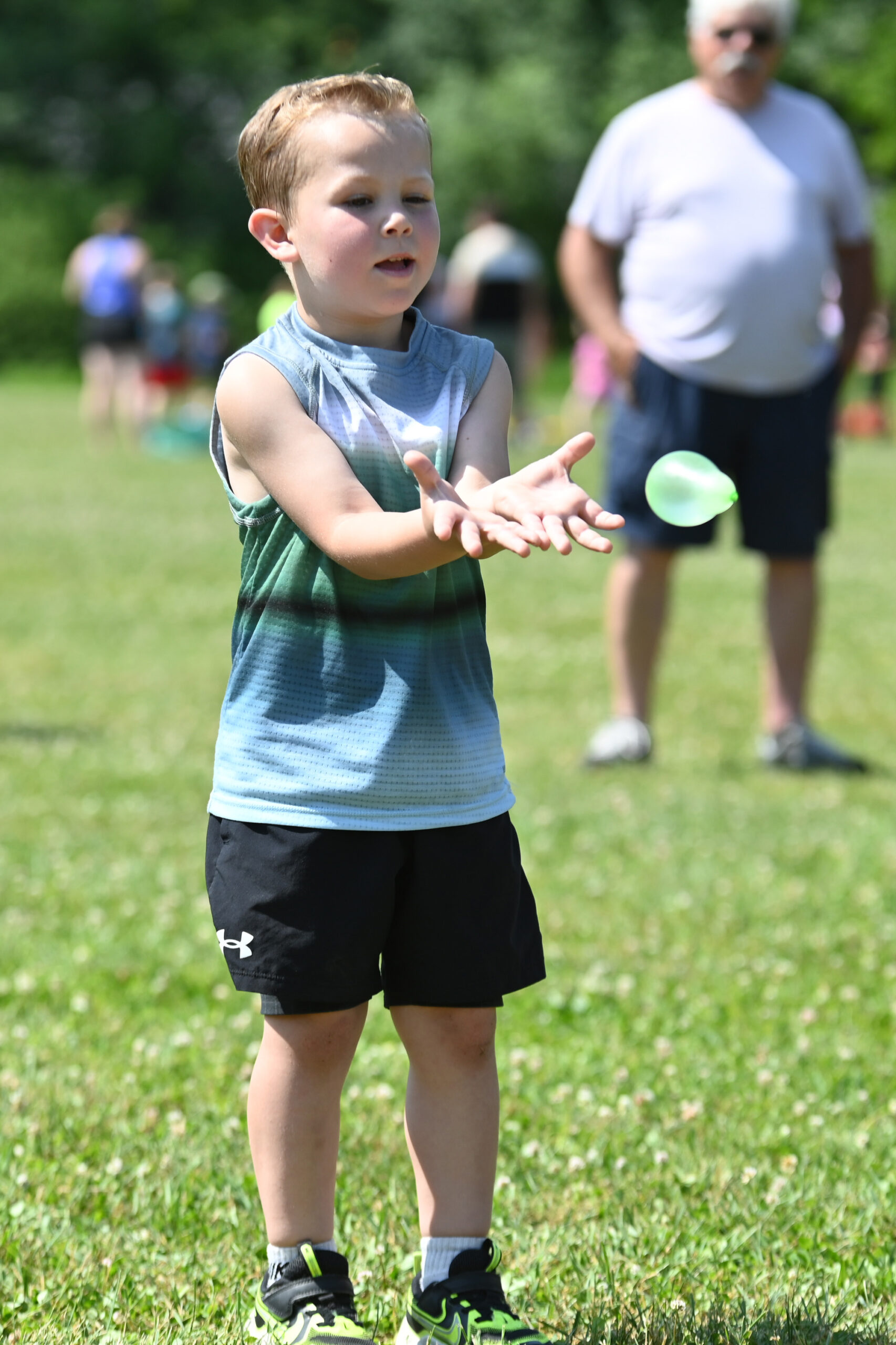 A student catches a water balloon at DPS Field Day