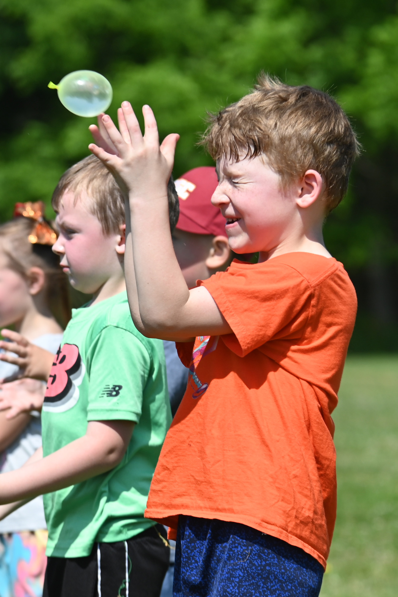 A student tries to catch a water balloon at DPS Field Day