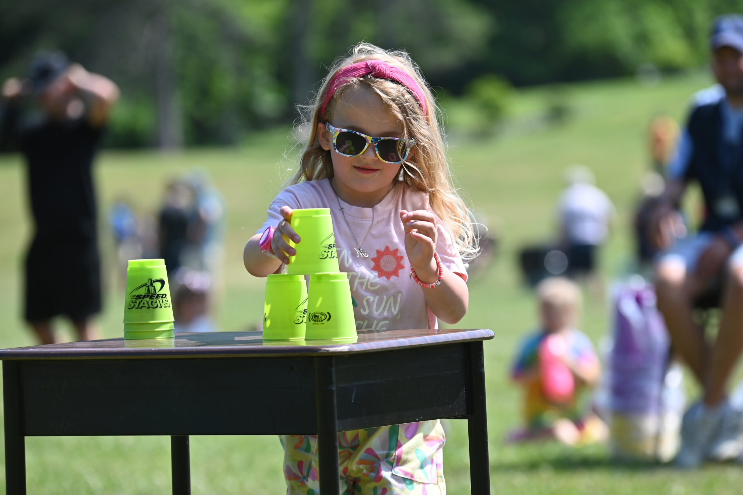 A student stacks cups during a race at DPS Field Day