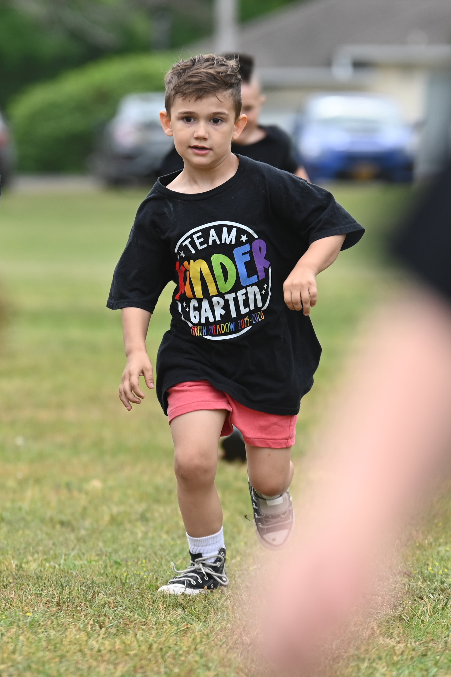 A student running at Green Meadow Kindergarten Field Day